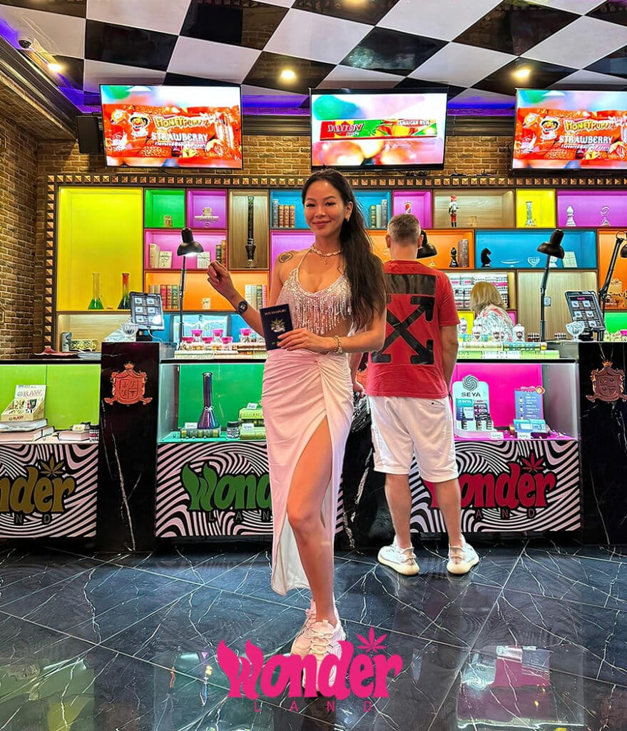 attractive thai lady holding pot passport at wonderland bangkok cannabis store